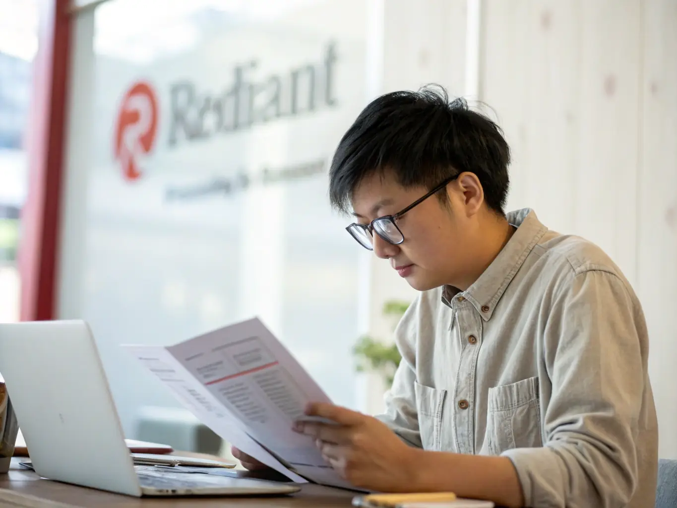 An image depicting a person reviewing loan documents with a Paygistix logo subtly placed in the background, highlighting the accessibility of personal loan options.